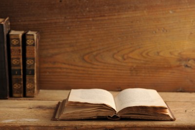 old book open on wooden shelf