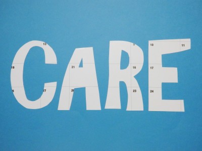 letters "CARE" cut from calendar