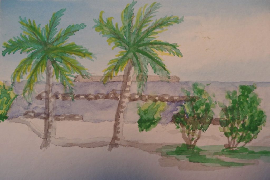 Informative Image: Watercolor painting of beach scene with rocks, bushes, and two palm  trees.